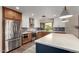 Modern kitchen with stainless steel appliances, a large island, and a window overlooking the backyard at 4839 E Marilyn Rd, Scottsdale, AZ 85254