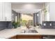 Bright kitchen sink featuring a large window with potted plants at 4839 E Marilyn Rd, Scottsdale, AZ 85254