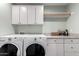 Well-organized laundry room features updated appliances, granite counters and upper cabinets at 4839 E Marilyn Rd, Scottsdale, AZ 85254