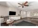 Bright living room features hardwood floors, ceiling fan, and a built-in cabinet at 4839 E Marilyn Rd, Scottsdale, AZ 85254