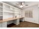 Office space features custom built-in shelving, workspace, neutral carpet, and bright window at 4839 E Marilyn Rd, Scottsdale, AZ 85254