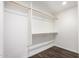 Bright walk-in closet with white walls and wooden shelves and bars at 4839 E Marilyn Rd, Scottsdale, AZ 85254