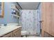 Bright bathroom featuring a vanity, toilet, and stylish floral shower curtain at 5524 E Harmon Cir, Mesa, AZ 85215