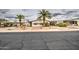 Inviting single-story home with palm trees, low maintenance landscape, and a well-kept exterior at 5524 E Harmon Cir, Mesa, AZ 85215