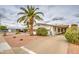 Pleasant single-story home with palm tree, attached covered parking, and low-maintenance landscaping at 5524 E Harmon Cir, Mesa, AZ 85215
