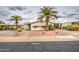 Attractive single-story home with palm trees, desert landscape, and a neatly maintained front yard at 5524 E Harmon Cir, Mesa, AZ 85215