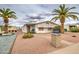 Charming single-story home featuring palm trees, a well-maintained yard, and a welcoming front entrance at 5524 E Harmon Cir, Mesa, AZ 85215