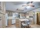 Well-lit kitchen featuring laminate countertops, wood cabinetry, and modern appliances at 5524 E Harmon Cir, Mesa, AZ 85215