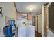Functional laundry room with washer, dryer, and overhead storage cabinets at 5524 E Harmon Cir, Mesa, AZ 85215