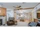 Living room and kitchen in an open layout with a breakfast bar, great for entertaining at 5524 E Harmon Cir, Mesa, AZ 85215