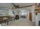 Spacious living area featuring plush sofas, ceiling fan, and open layout to the dining area at 5524 E Harmon Cir, Mesa, AZ 85215