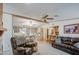 Open-concept living room with seating area, bar, and a kitchen featuring an island with barstools at 5524 E Harmon Cir, Mesa, AZ 85215