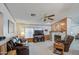 Inviting living room features a stone fireplace, wood paneling, and comfortable leather seating at 5524 E Harmon Cir, Mesa, AZ 85215