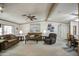 Comfortable living room with ceiling fans, neutral carpet, and classic decor at 5524 E Harmon Cir, Mesa, AZ 85215