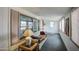 Enclosed porch with carpeting, whitewall paneling, windows, lamps and door to the exterior at 5524 E Harmon Cir, Mesa, AZ 85215