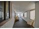 Enclosed porch with carpeting, whitewall paneling, lamps, and furniture and view to the backyard at 5524 E Harmon Cir, Mesa, AZ 85215