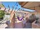 Outdoor patio with brick features, hammock, and string lights, creating a cozy and inviting space at 6320 N 4Th Pl, Phoenix, AZ 85012