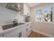 Updated kitchen with stainless hood, white cabinets, quartz counters and modern appliances at 6320 N 4Th Pl, Phoenix, AZ 85012