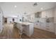 Modern kitchen with stainless steel appliances, white cabinets, and a large island with seating at 6320 N 4Th Pl, Phoenix, AZ 85012