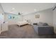 Large main bedroom with light walls, carpet, ceiling fan, and a comfy sitting area at 6320 N 4Th Pl, Phoenix, AZ 85012