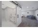 Spacious main bedroom featuring a barn door to the ensuite bathroom, plush carpet and light gray walls at 6320 N 4Th Pl, Phoenix, AZ 85012