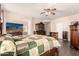 Bright bedroom with hardwood floors, ceiling fan, and comfortable bed at 6822 W Alta Vista Rd, Laveen, AZ 85339