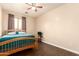 Bedroom features wood-look flooring, a ceiling fan, and neutral paint at 6822 W Alta Vista Rd, Laveen, AZ 85339