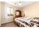 Cozy bedroom featuring neutral walls, ceiling fan, and a wood-look floor at 6822 W Alta Vista Rd, Laveen, AZ 85339