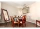 Cozy dining area with wood-style flooring, vintage table, and a full length mirror at 6822 W Alta Vista Rd, Laveen, AZ 85339