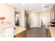 Spacious kitchen with stainless steel refrigerator and wood floors, adjacent to dining area at 6822 W Alta Vista Rd, Laveen, AZ 85339
