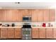 Bright kitchen featuring stainless steel appliances, ample counter space and wood cabinets at 6822 W Alta Vista Rd, Laveen, AZ 85339