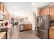 Spacious open-concept kitchen featuring stainless steel appliances and wood cabinets at 6822 W Alta Vista Rd, Laveen, AZ 85339