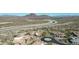 Beautiful aerial view of luxury homes, desert landscaping, and stunning mountain views in the distance at 7013 E Summit Trail Cir, Mesa, AZ 85207