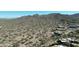 Scenic aerial of desert landscape, mountain views, and luxury homes nestled into the hillside at 7013 E Summit Trail Cir, Mesa, AZ 85207