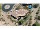 Beautiful desert estate with lush landscaping, a sparkling pool with a spa, and a circular driveway at 7013 E Summit Trail Cir, Mesa, AZ 85207
