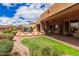 Backyard boasts an outdoor kitchen and lush landscaping, perfect for entertaining at 7013 E Summit Trail Cir, Mesa, AZ 85207
