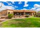 Manicured backyard with desert landscaping and views of the home's covered patio at 7013 E Summit Trail Cir, Mesa, AZ 85207