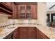 Wet bar features wine storage, granite counters, and custom cabinetry at 7013 E Summit Trail Cir, Mesa, AZ 85207