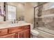 Bathroom featuring a wooden cabinet, white countertop, and a shower/tub combo at 7013 E Summit Trail Cir, Mesa, AZ 85207