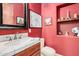 Bright bathroom featuring a marble countertop, red walls, and a charming Parisian theme at 7013 E Summit Trail Cir, Mesa, AZ 85207