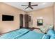 Comfortable bedroom with TV, ceiling fan, ensuite bathroom and walk in closet at 7013 E Summit Trail Cir, Mesa, AZ 85207