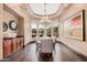 Formal dining room with elegant chandelier, large windows, and a stylish dining set at 7013 E Summit Trail Cir, Mesa, AZ 85207