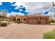 Stunning home exterior with a spacious driveway and a three-car garage at 7013 E Summit Trail Cir, Mesa, AZ 85207