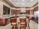 Gourmet kitchen with granite countertops, wood cabinetry, and stainless steel appliances at 7013 E Summit Trail Cir, Mesa, AZ 85207