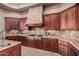 Close-up of a gourmet kitchen featuring high-end appliances and stone accents at 7013 E Summit Trail Cir, Mesa, AZ 85207