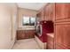 Laundry room features a window, custom cabinetry, sink and modern washer and dryer at 7013 E Summit Trail Cir, Mesa, AZ 85207