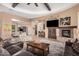 Spacious living room features a stone fireplace, beamed ceilings, and an open floor plan at 7013 E Summit Trail Cir, Mesa, AZ 85207