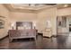 Spacious main bedroom with dark wood floors, tray ceiling, and luxurious finishes at 7013 E Summit Trail Cir, Mesa, AZ 85207