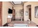 Home office with a desk, tv, and French doors to welcome you inside at 7013 E Summit Trail Cir, Mesa, AZ 85207