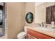Stylish powder room featuring a unique art piece and a view to the outside at 7013 E Summit Trail Cir, Mesa, AZ 85207